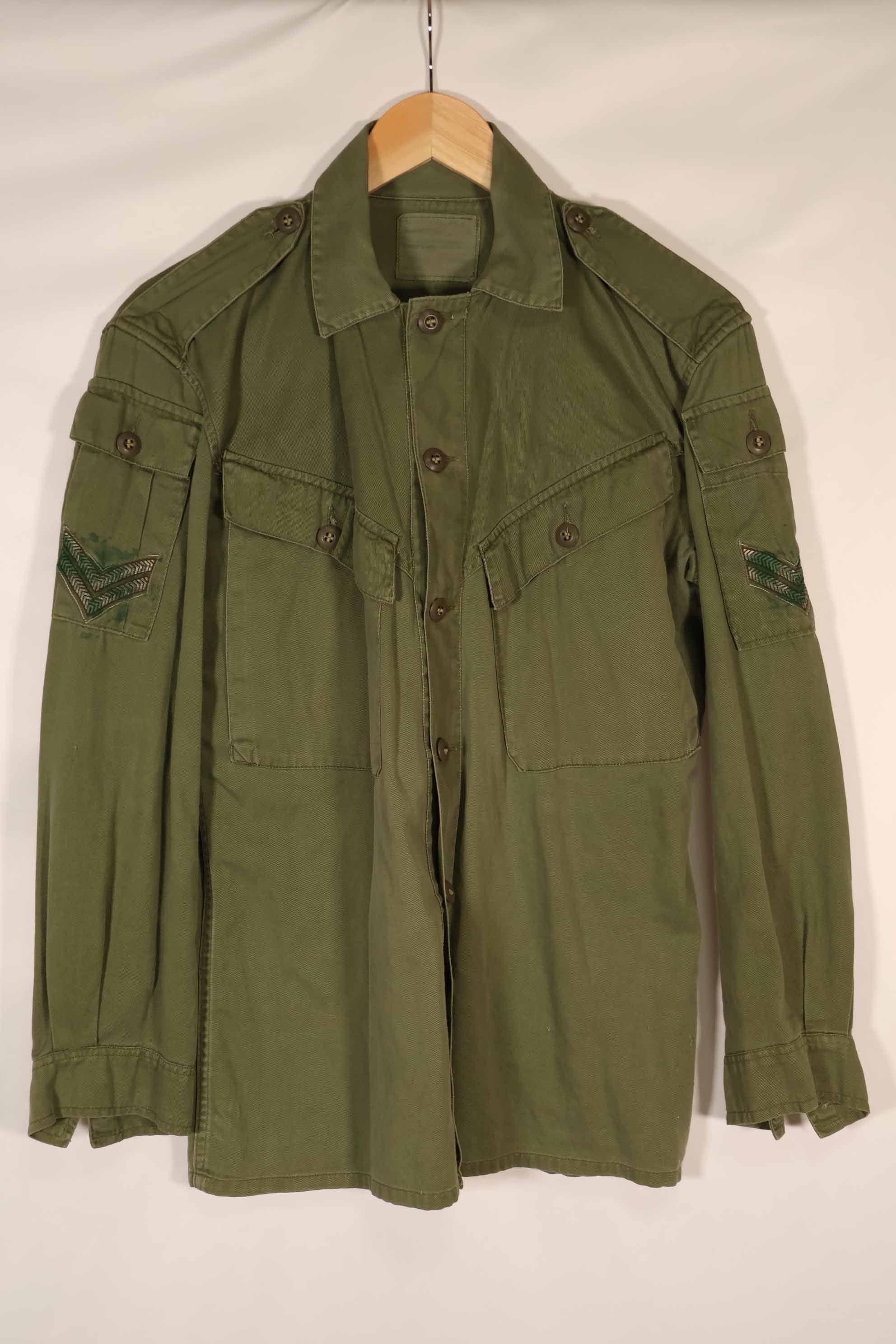 Real 1970 Australian Army OD Fatigue shirt with rank insignia, size unreadable.