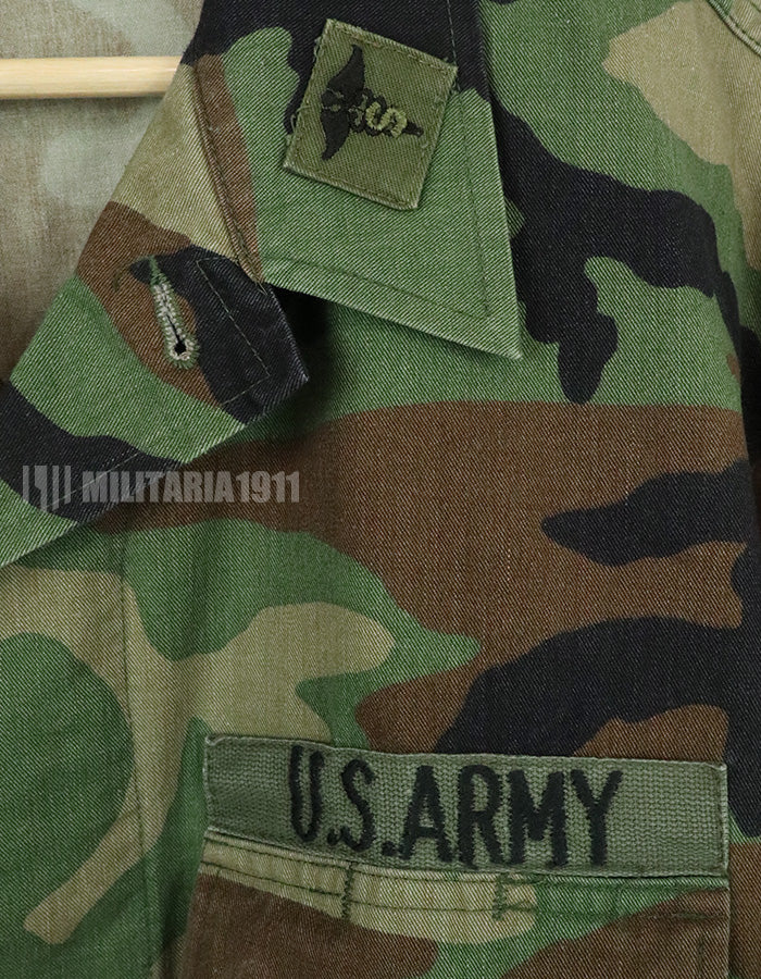 Original U.S. Army Woodland Camouflage Jacket with patches, 1990.