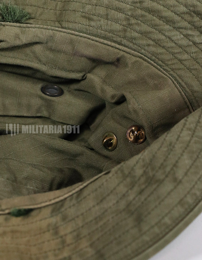 Real U.S. Army boonie hat with metal insignia, faded.